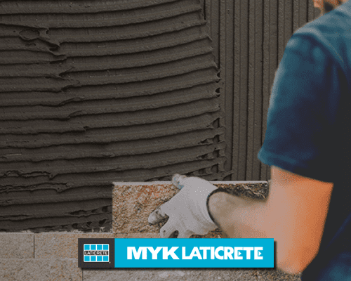 Technician fixing tiles using MYK Laticrete adhesive.