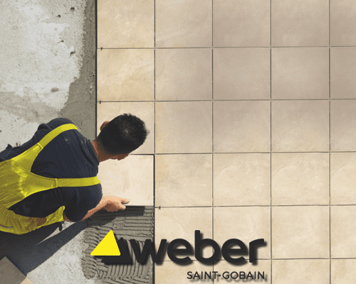Technician fixing tiles using weber adhesive