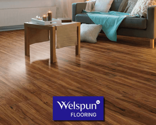 Modern looking living room with chair and center table featuring Welspun premium wooden flooring